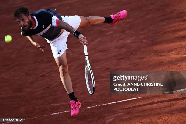 France's Corentin Moutet serves to Russia's Andrey Rublev during their men's singles match on day four of the Roland-Garros Open tennis tournament at...