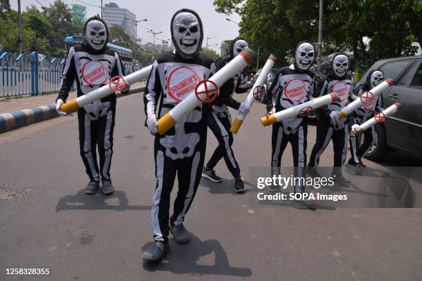 People from the health awareness community dressed up as skeletons participate in a rally to spread awareness against the harmful effects of tobacco...