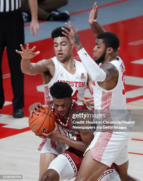 Temple Owls guard Jeremiah Williams gets squeezed by Houston Cougars forward Reggie Chaney and guard Quentin Grimes during the first half of an NCAA...