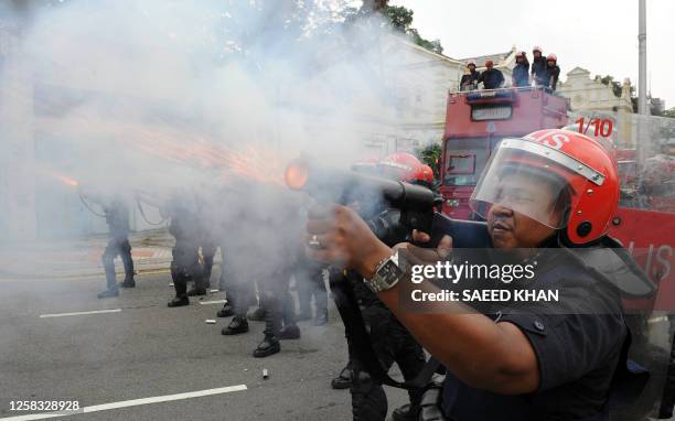Malaysian anti-riot police fire tear gas shells to disperse demonstrators near Merdeka Square in Kuala Lumpur on August 1, 2009. Malaysian police...