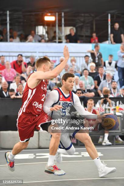 Karlis Lasmanis of Latvia vies with Jimmer Fredette of the USA during the mens pool play match between the USA and Latvia on Day 2 of the FIBA 3x3...