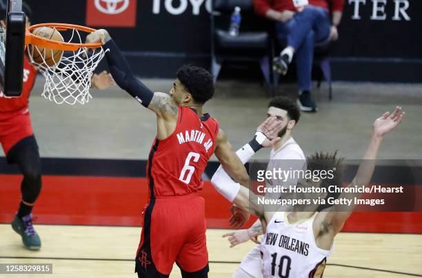 Houston Rockets forward Kenyon Martin Jr. Dunks the ball over New Orleans Pelicans center Jaxson Hayes during the second half of an NBA basketball...