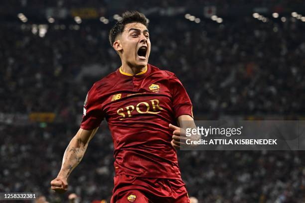 Roma's Argentinian forward Paulo Dybala celebrates scoring the opening goal during the UEFA Europa League final football match between Sevilla FC and...