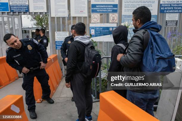 Customs and Border Protection agents allow asylum seekers from Venezuela to enter the country at the San Ysidro crossing port on the US-Mexico...