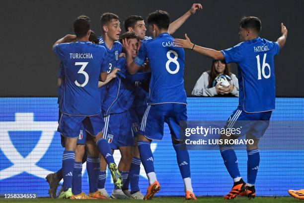 Italy's midfielder Tommaso Baldanzi celebrates with his teammates after scoring a goal during the Argentina 2023 U-20 World Cup round of 16 football...