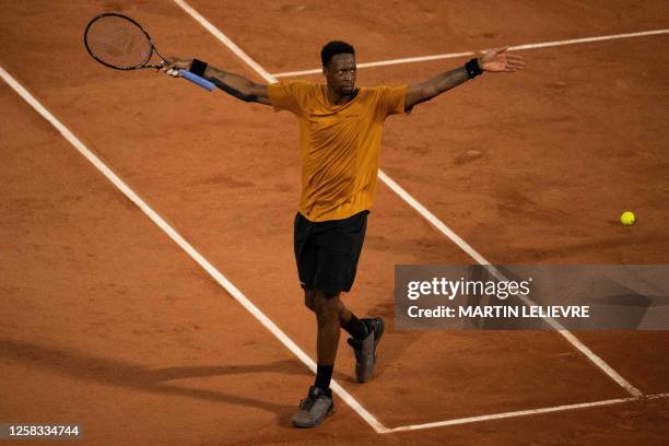 France's Gael Monfils celebrates his victory over Argentina's Sebastian Baez during their men's singles match on day three of the Roland-Garros Open...