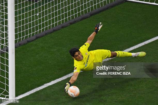 Sevilla's Moroccan goalkeeper Yassine Bounou dives after a penalty during the UEFA Europa League final football match between Sevilla FC and AS Roma...