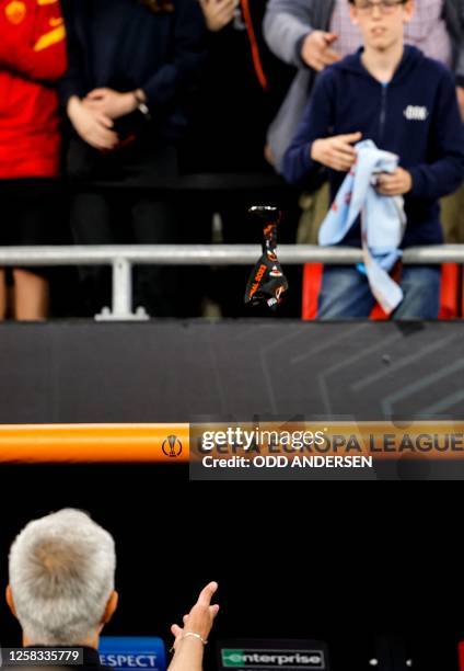 Roma's Portuguese coach Jose Mourinho throws his runners-up medal into the crowd after the UEFA Europa League final football match between Sevilla FC...