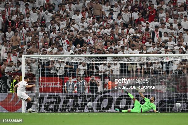 Sevilla's Argentinian defender Gonzalo Montiel has his first penalty saved by AS Roma's Portuguese goalkeeper Rui Patricio during the penalty...