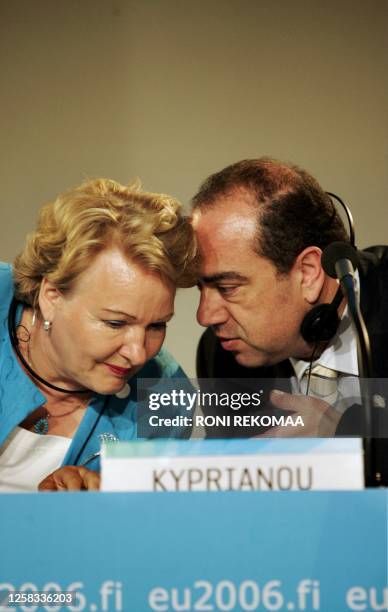 Commissioner of Health and Consumer Protection Markos Kyprianou whispers to Finnish Minister of Health and Social Services Liisa Hyssala during a...