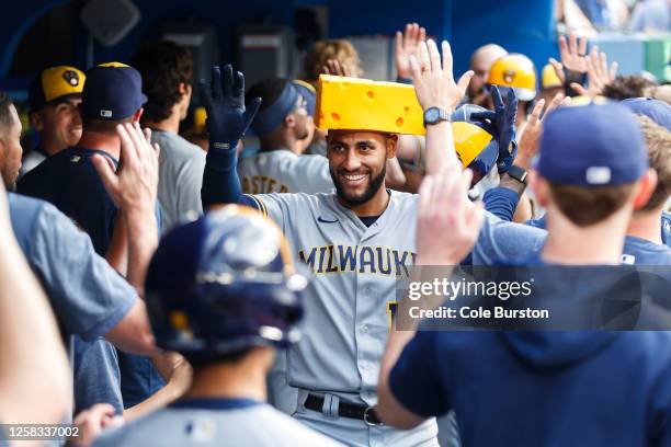 Abraham Toro of the Milwaukee Brewers celebrates a two-run home run in the dugout during the second inning of their MLB game against the Toronto Blue...