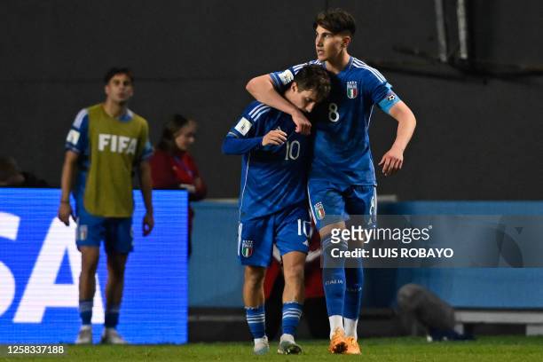 Italy's midfielder Cesare Casadei celebrates with teammate midfielder Tommaso Baldanzi after scoring a goal from the penalty spot during the...