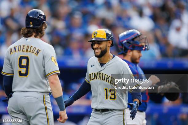 Abraham Toro of the Milwaukee Brewers celebrates his two-run home run with Brian Anderson in the second inning of their MLB game against the Toronto...