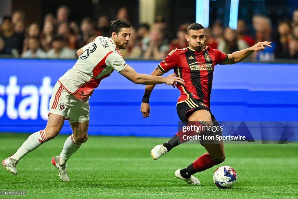 Atlanta forward Giorgos Giakoumakis makes a move while defended by ...