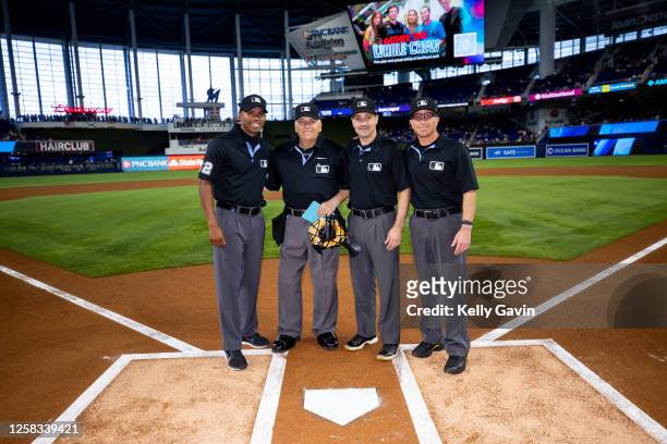 Umpires Edwin Moscoso, Larry Vanover, David Rackley, and Chris Guccione pose for a photo before the game between the New York Mets and the Miami...