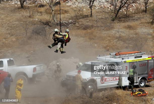 Forensic experts work with several bags of human remains extracted from the bottom of a ravine by a helicopter, which were abandoned at the Mirador...