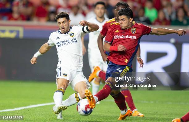 Brayan Vera of Real Salt Lake tries to clear the ball against Gaston Brugman of the Los Angeles Galaxy during the second half of their game at...