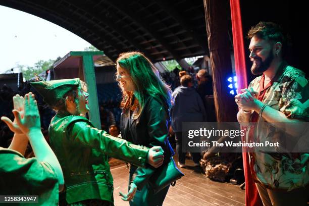 Peyton Stratton, who was playing the dual roles of Robin Hood and Maid Marian, left, greets Carroll High School drama teacher while the play's...