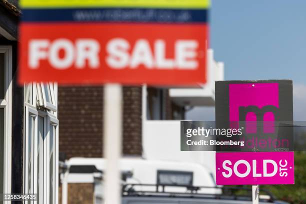 Estate agent's "Sold" and "For Sale" signs outside residential houses in Worthing, UK, on Wednesday, May 31, 2023. UK house prices resumed their...
