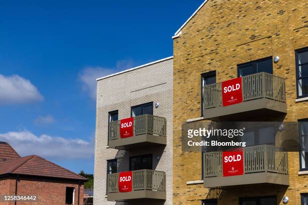 Sold signs on the balconies of a newly constructed residential apartment block, developed by Countryside Partnerships Ltd., in Ebbsfleet, UK, on...