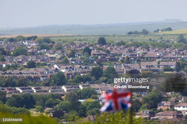 British Union flag near residential properties in a suburb of Brighton, UK, on Wednesday, May 31, 2023. UK house prices resumed their decline, with...