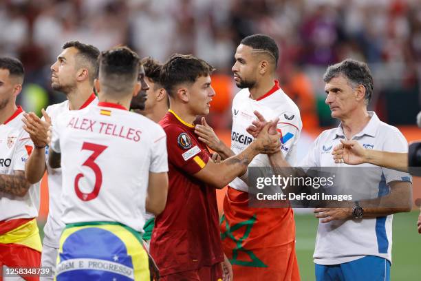 Jose Luis Mendilibar head coach of Sevilla FC greets Paulo Dybala of AS Roma during the award ceremony after the UEFA Europa League 2022/23 final...