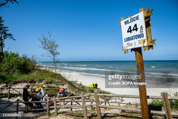 Beach sign with stickers "yes for atom" and "atom stop" seen in Lubiatowo a few kilometers from the planned construction of a nuclear power plant in...