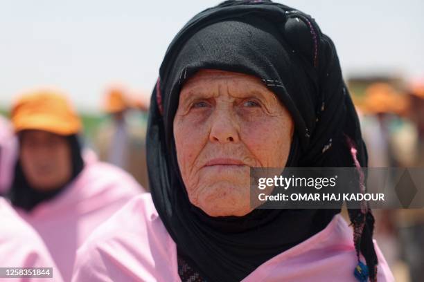 An elderly Syrian woman joins Muslim pilgrims attending a training session on performing the rituals of Hajj and travel procedures to Mecca in the...