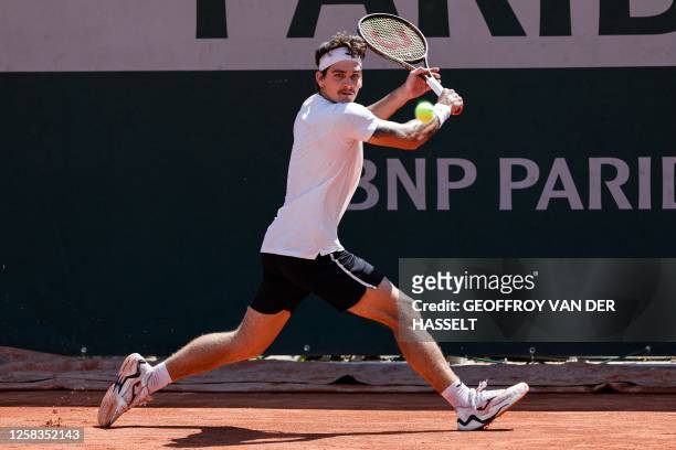 Brazil's Thiago Seyboth Wild plays a backhand return to Argentina's Guido Pella during their men's singles match on day five of the Roland-Garros...