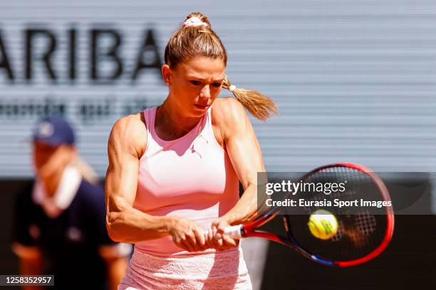 Camila Giorgi of Italy plays a backhand against Jessica Pegula of USA during their Singles First Round Match on Day Four of the 2023 French Open at...