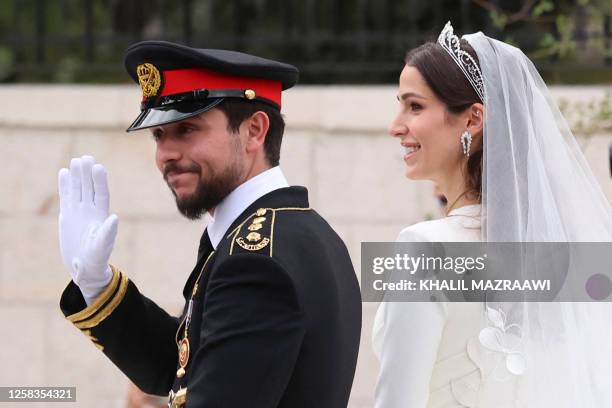 Jordan's Crown Prince Hussein and his wife Saudi Rajwa al-Seif leave in a convoy following their royal wedding ceremony in Amman on June 1, 2023. The...