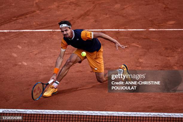Germany's Daniel Altmaier plays a forehand return to Italy's Jannik Sinner during their men's singles match on day five of the Roland-Garros Open...