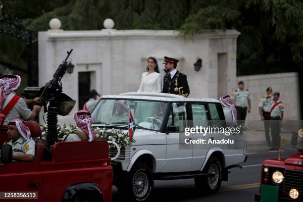 Jordanese Crown Prince Al Hussein bin Abdullah II and Saudi architect Rajwa Alseif head to the Al Husseiniya Palace after their wedding ceremony at...