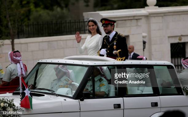 Jordanese Crown Prince Al Hussein bin Abdullah II and Saudi architect Rajwa Alseif head to the Al Husseiniya Palace after their wedding ceremony at...