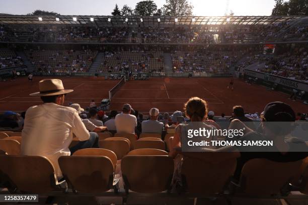Spectators watch a men's singles match on day five of the Roland-Garros Open tennis tournament at the Court Suzanne-Lenglen in Paris on June 1, 2023.
