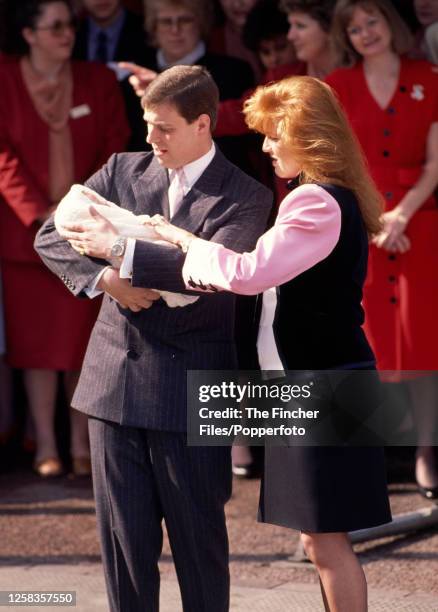 Prince Andrew with his wife Sarah The Duchess of York and new-born daughter Princess Eugenie leaving Portland Hospital in London on 30th March 1990.