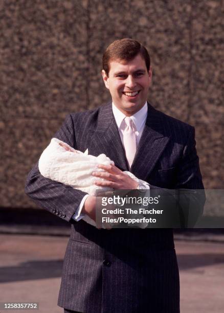 Prince Andrew holding new-born daughter Princess Eugenie whilst leaving Portland Hospital in London on 30th March 1990.