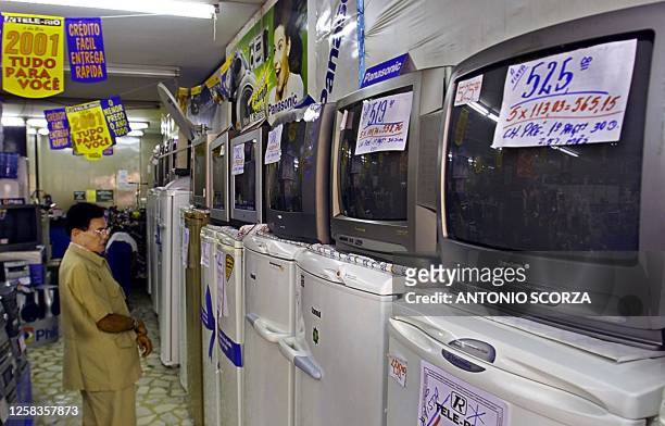 Client looks at a television display, 22 May 2001, in Rio de Janeiro, Brazil, where they intend to decrease consumer use of electrical energy. Un...