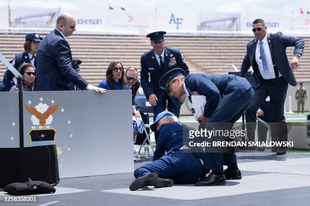 President Joe Biden is helped up after falling during the graduation ceremony at the United States Air Force Academy, just north of Colorado Springs...