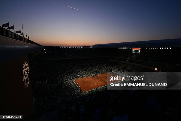 General view shows the Court Philippe-Chatrier at sunset during the men's singles match between Germany's Alexander Zverev and Slovakia's Alex Molcan...