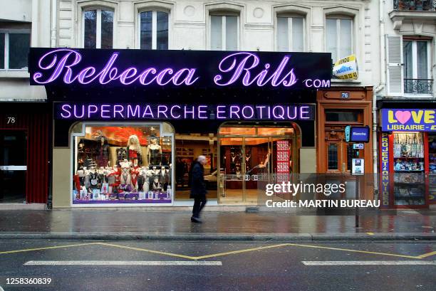 Man walks 03 February 2003 in front of the newly opened Supermarche Erotique located in Paris's red-light district, Pigalle. The store is divided in...