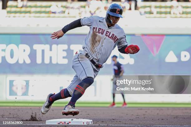 Andres Gimenez of the Cleveland Guardians rounds third base to score on a hit by Will Brennan during the second inning at Target Field against the...