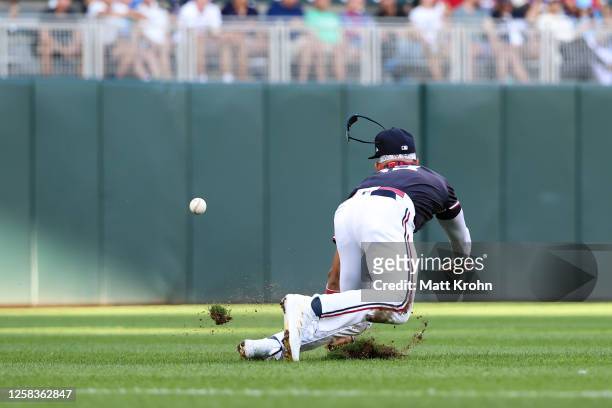 Royce Lewis of the Minnesota Twins attempts to catch a fly ball hit by Andres Gimenez of the Cleveland Guardians during the second inning at Target...