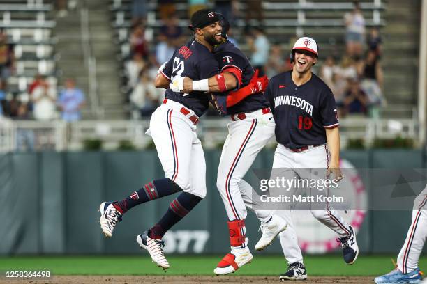 Willi Castro of the Minnesota Twins celebrates with teammates his walk-off sacrifice fly during the ninth inning against the Cleveland Guardians at...