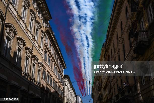 Aermacchi MB-339 aircrafts of the Italian Air Force aerobatic unit "Frecce Tricolori" spread smoke with the colors of the Italian flag over Via del...