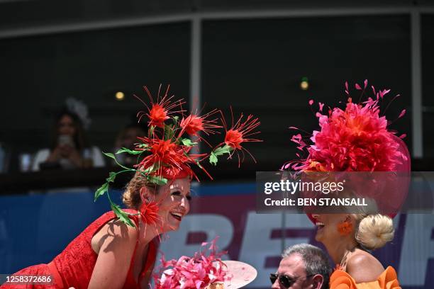 Racegoers enjoy the sunshine on the first day of the Epsom Derby Festival horse racing event in Surrey, southern England on June 2, 2023.