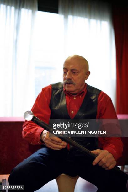The French antique dealer and walking sticks collector Gilbert Segas takes in his hands a cane for clairvoyant in his store located in the passage...