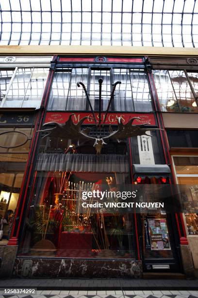 The storefront of the French antique dealer and walking stick collector Gilbert Segas located in passage Jouffroy, in Paris shows some of his cane...