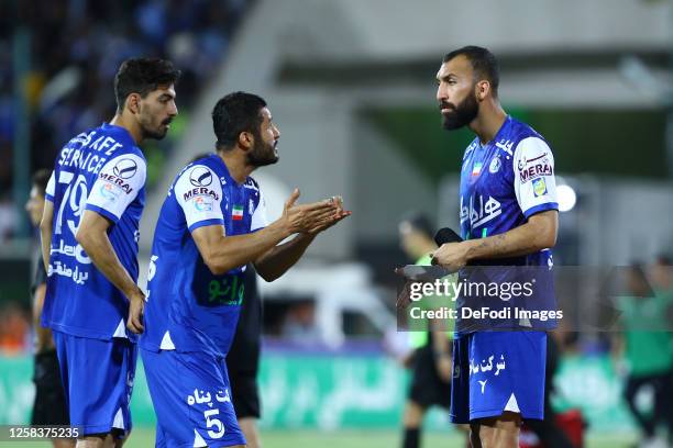 Aref Gholami of Esteghlal FC speaks with Rouzbeh Cheshmi of Esteghlal FC after the Hazfi Cup match between Persepolis FC and Esteghlal FC on May 31,...