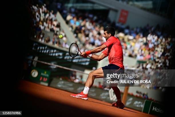 Serbia's Novak Djokovic plays a backhand return to Spain's Alejandro Davidovich Fokina during their men's singles match on day six of the...